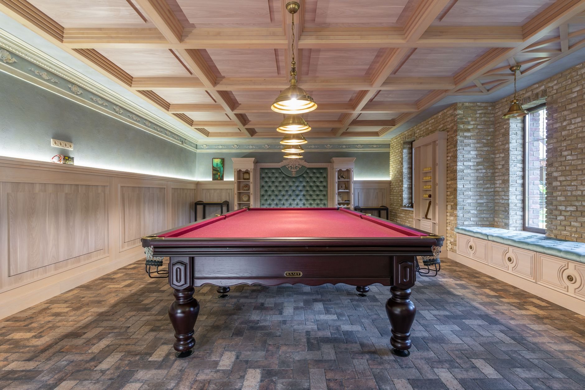 Luxurious billiard room featuring red table and vintage wooden interior design.